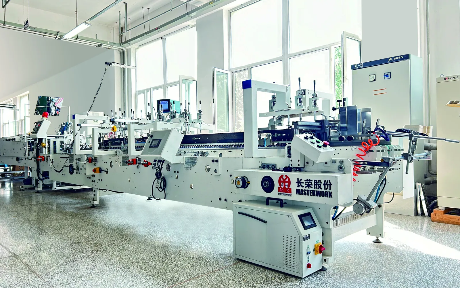 Masterwork automatic folder gluer on a packaging production floor