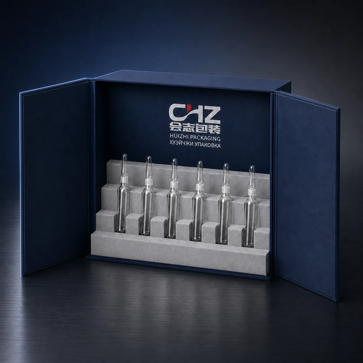 Open navy double-door rigid cosmetic box displaying six glass serum ampoules in a stepped silver insert.