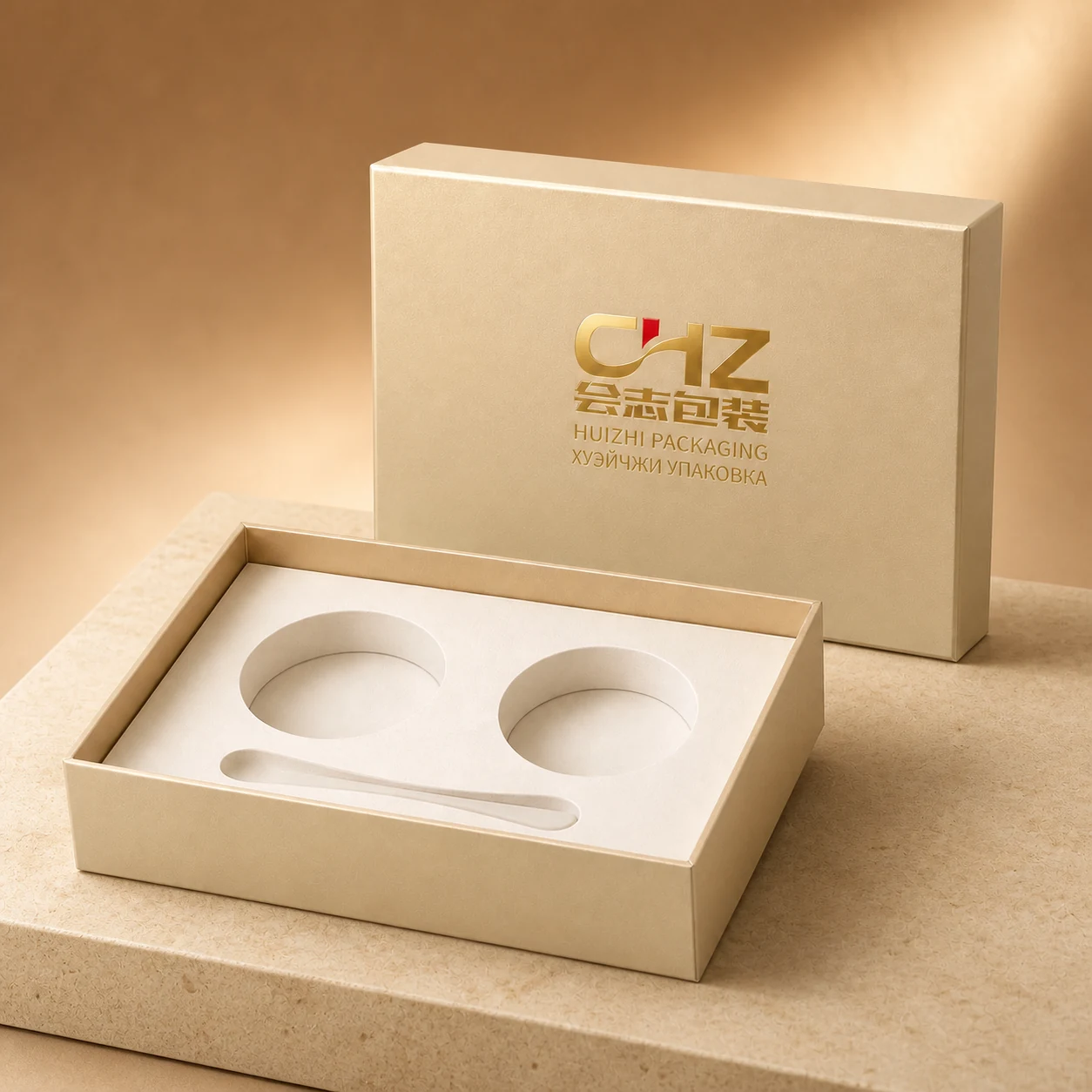 Champagne gold lift-off cosmetic box with two round jar cavities and one slim accessory slot in an ivory insert.
