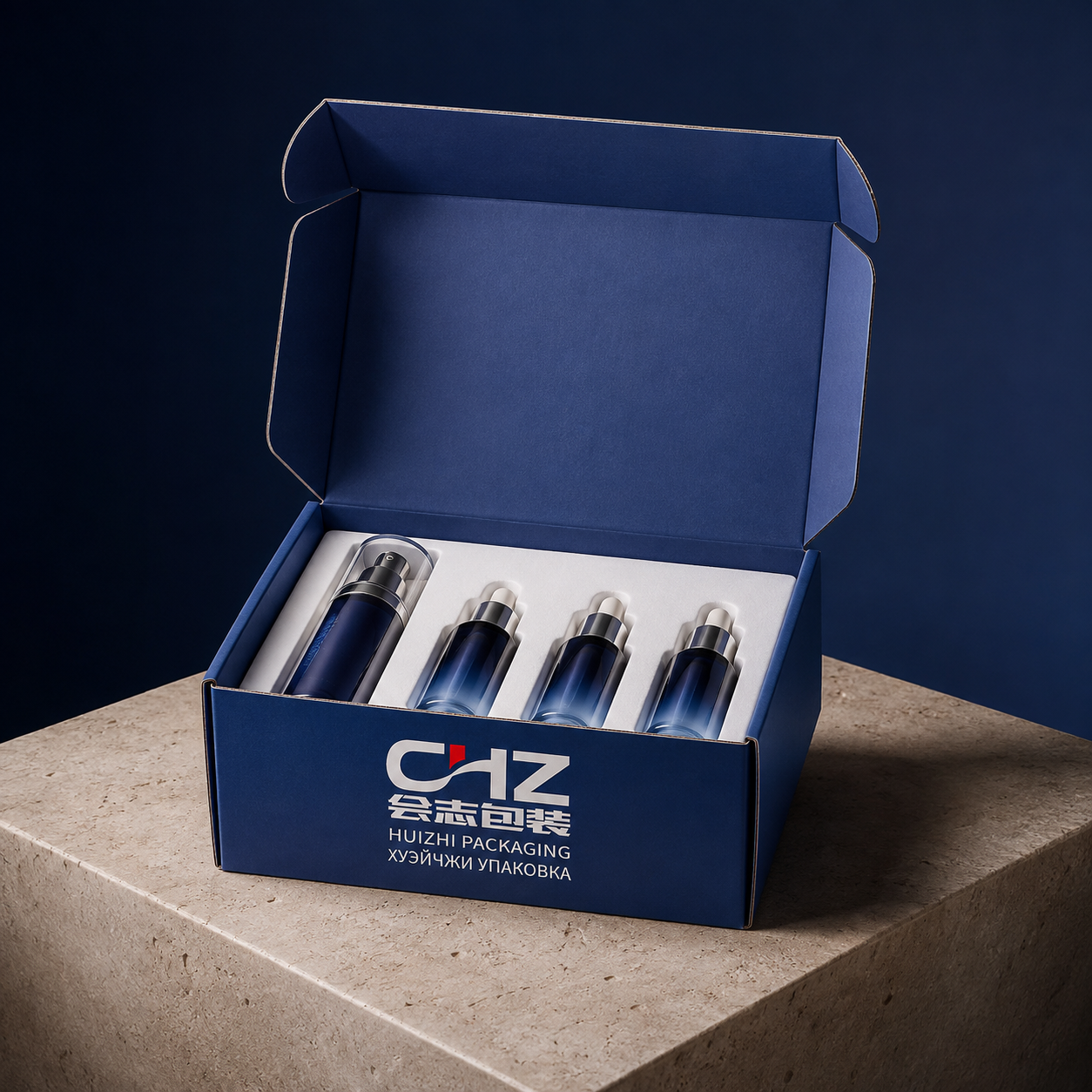 Open navy folding carton with Huizhi Packaging logo and a white insert holding a skincare pump bottle and four small vials.