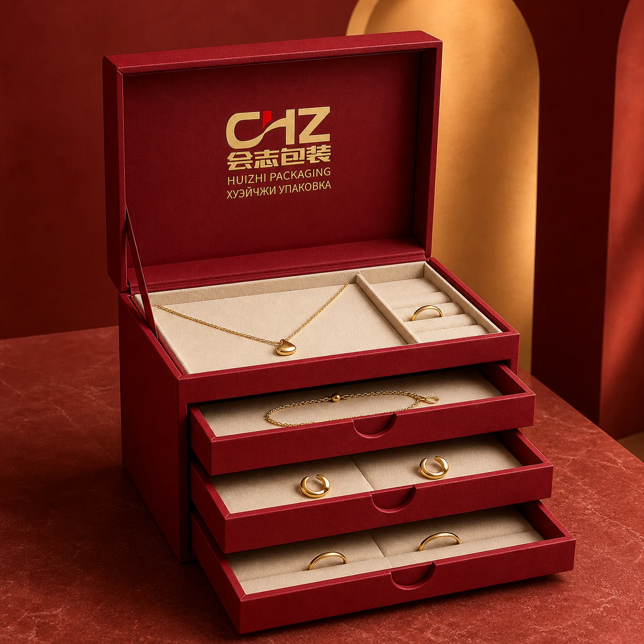 Deep red multi-level jewelry box with an open top compartment and three shallow pull-out drawers.